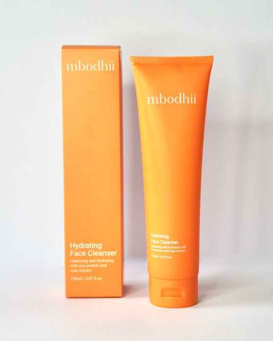 Orange tube and box of mbodhi hydrating face cleanser on a white background