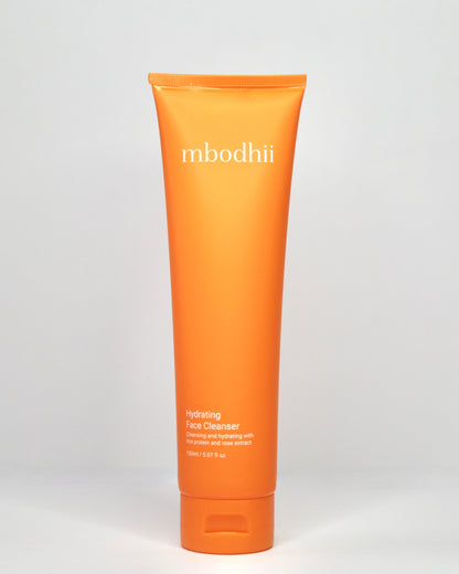 mbodii Hydrating Face Cleanser in an orange tube on a white background